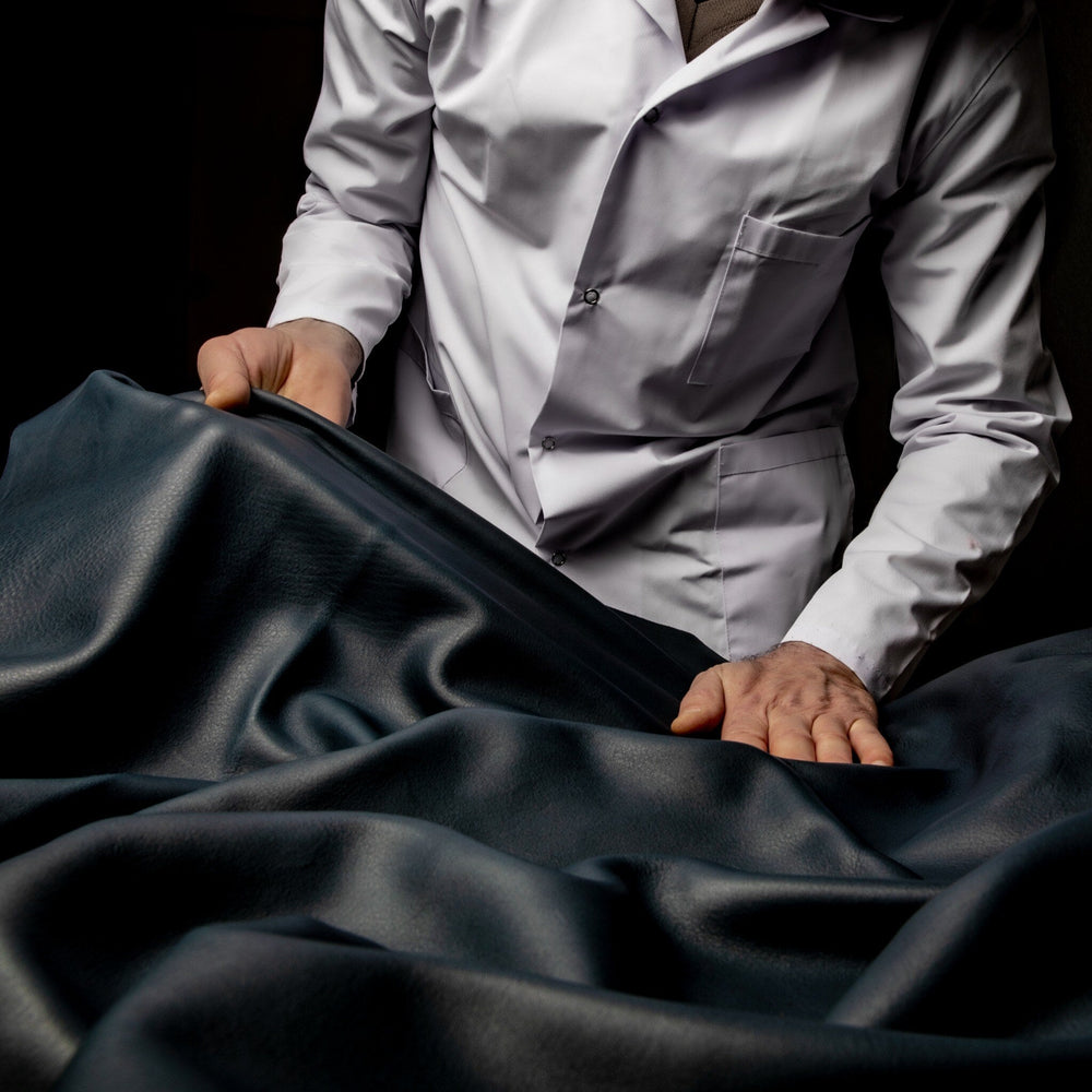 Leather specialist examining the grain and texture of a hide